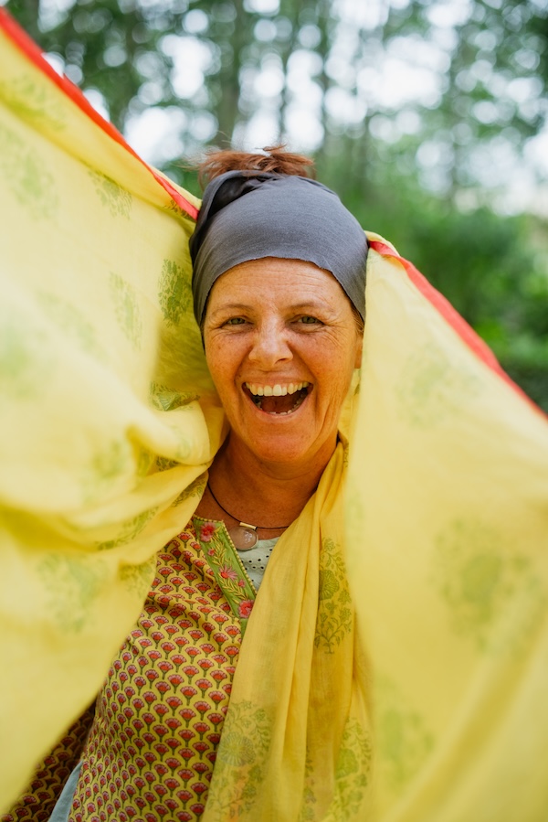 AstroLainy portrait with smiling face and yellow scarf